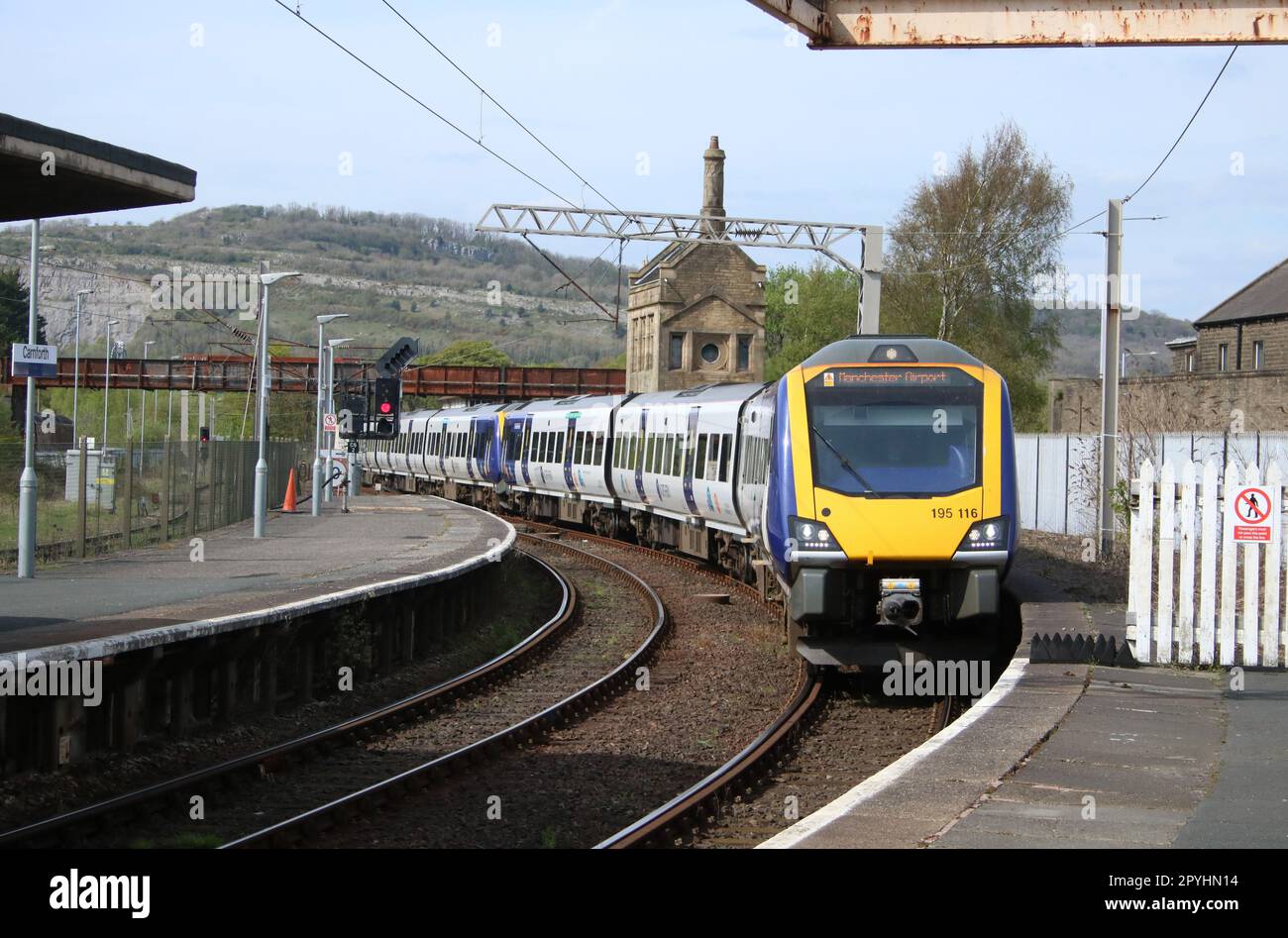 Two Northern trains class 195 civity diesel multiple-units arriving at Carnforth station with Manchester Airport train on 3rd May 2023. Stock Photo