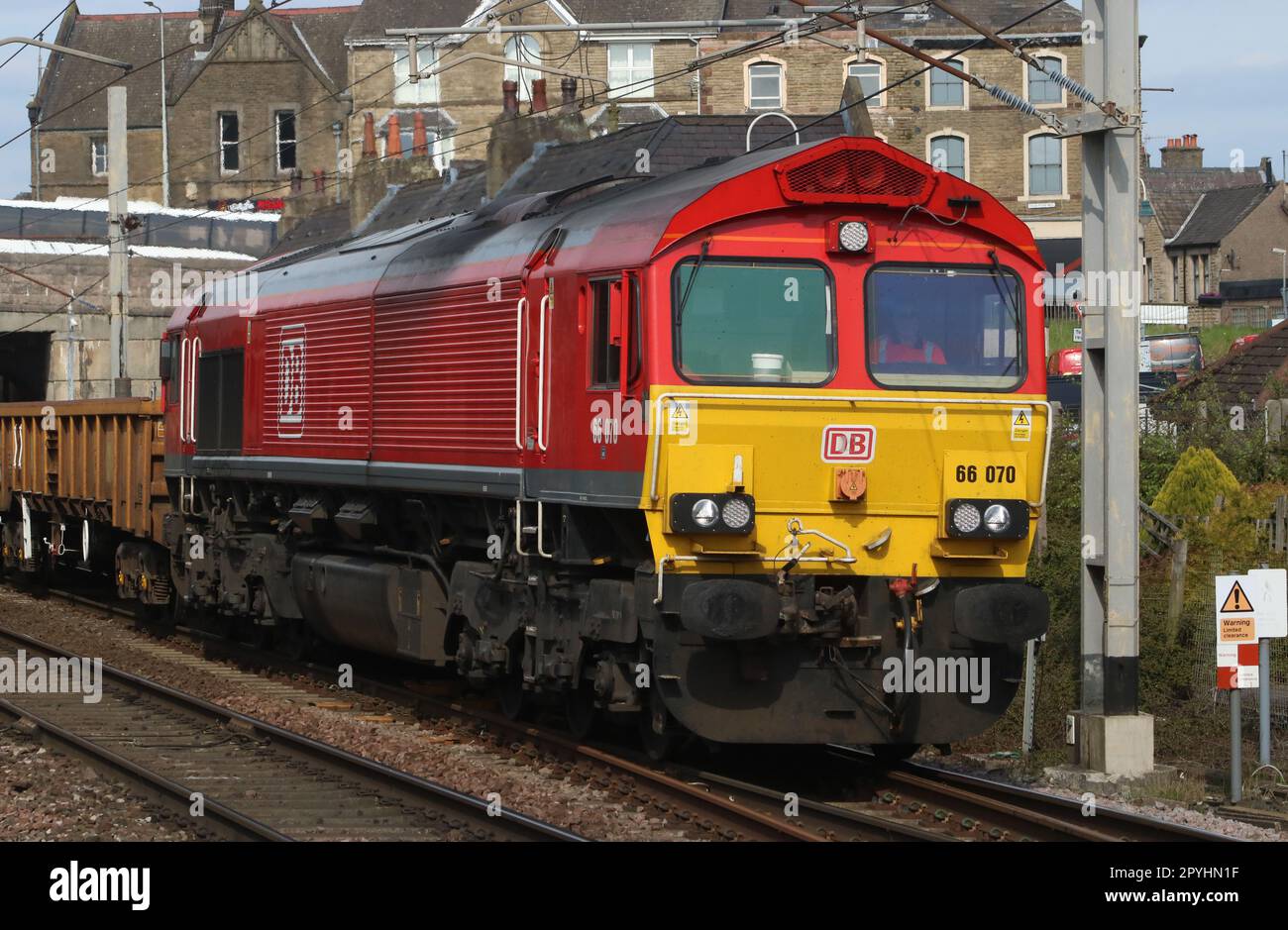 DB Cargo UK red liveried class 66 shed diesel-electric loco, 66070, hauling an engineers train through Carnforth on West Coast Main Line 3rd May 2023. Stock Photo