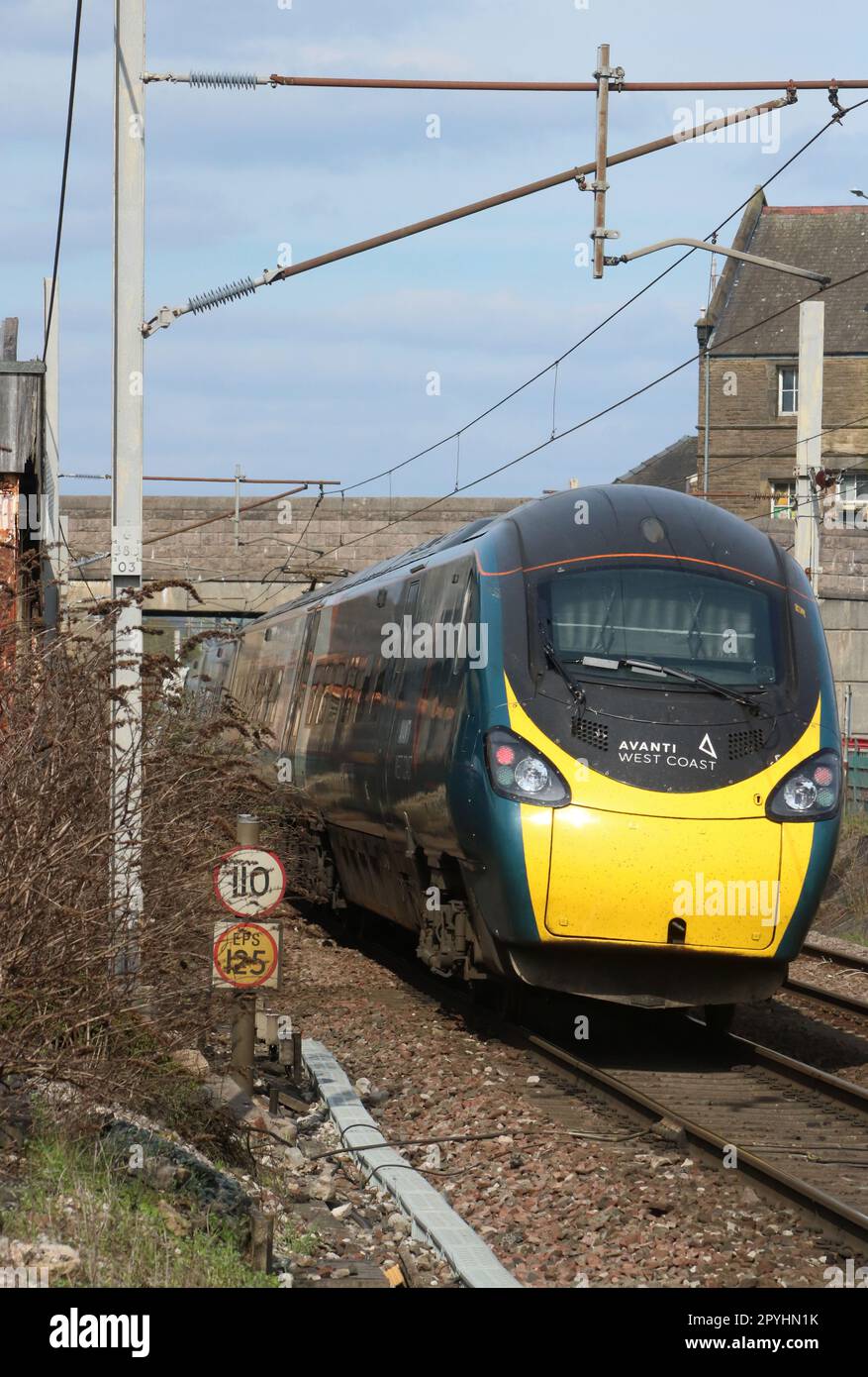 Avanti West Coast class 390 pendolino electric multiple unit 390125 at Carnforth on West Coast Main Line with express passenger train, 3rd May 2023. Stock Photo