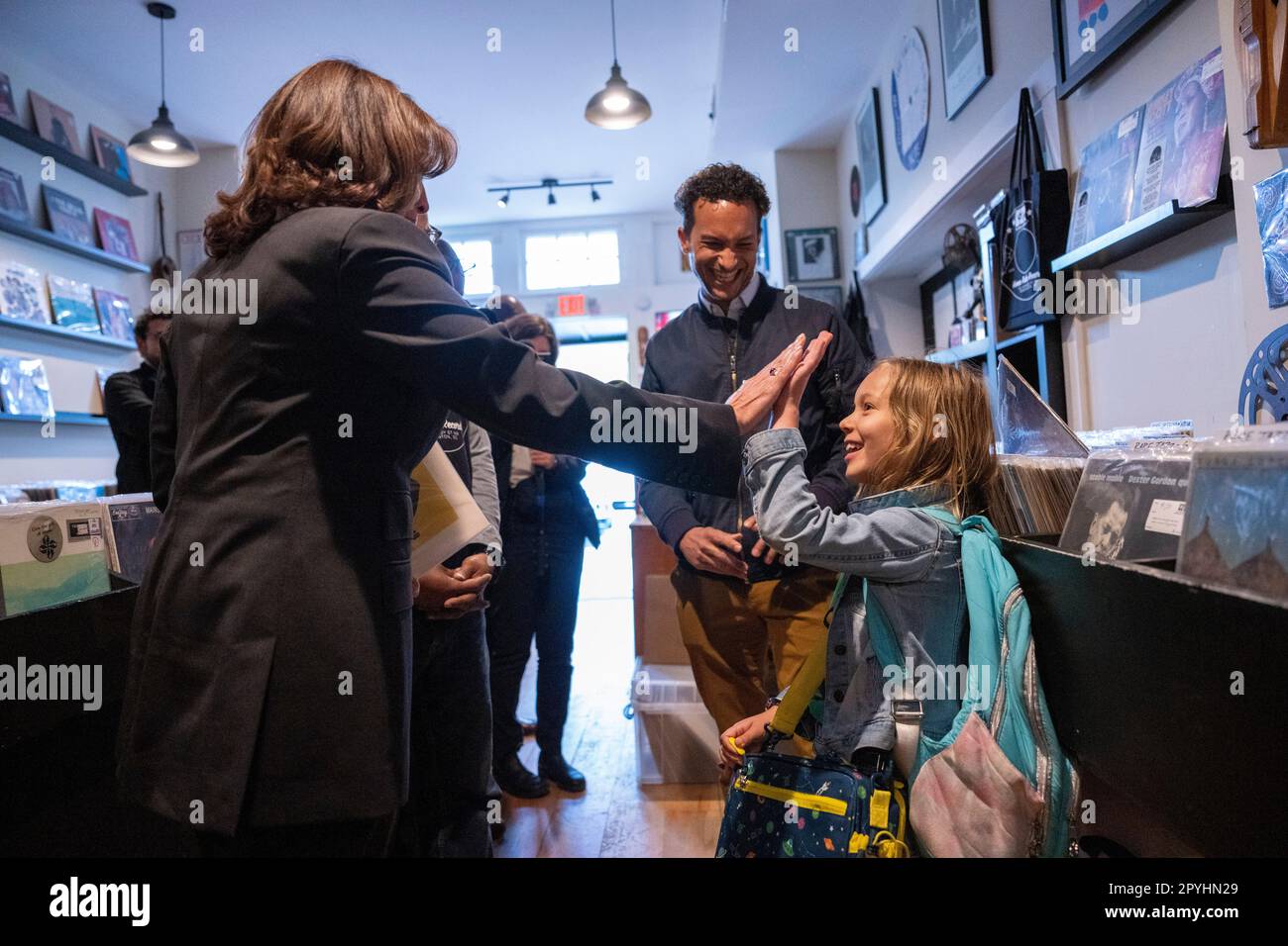 Washington, United States. 03rd May, 2023. U.S. Vice President Kamala Harris high-fives with Esmé Pleasant as her father Zach looks on at Home Rule Record store in Washington, DC on Wednesday, May 3, 2023. Photo by Ken Cedeno/Pool/Sipa USA Credit: Sipa USA/Alamy Live News Stock Photo