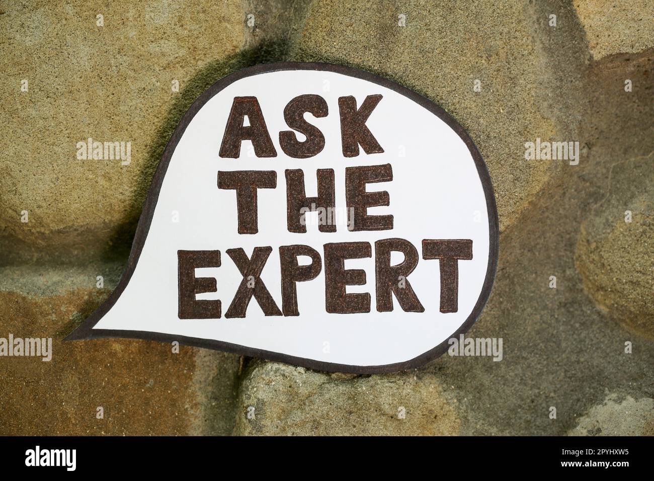Paper message bubble with phrase Ask The Expert on ground, top view Stock Photo