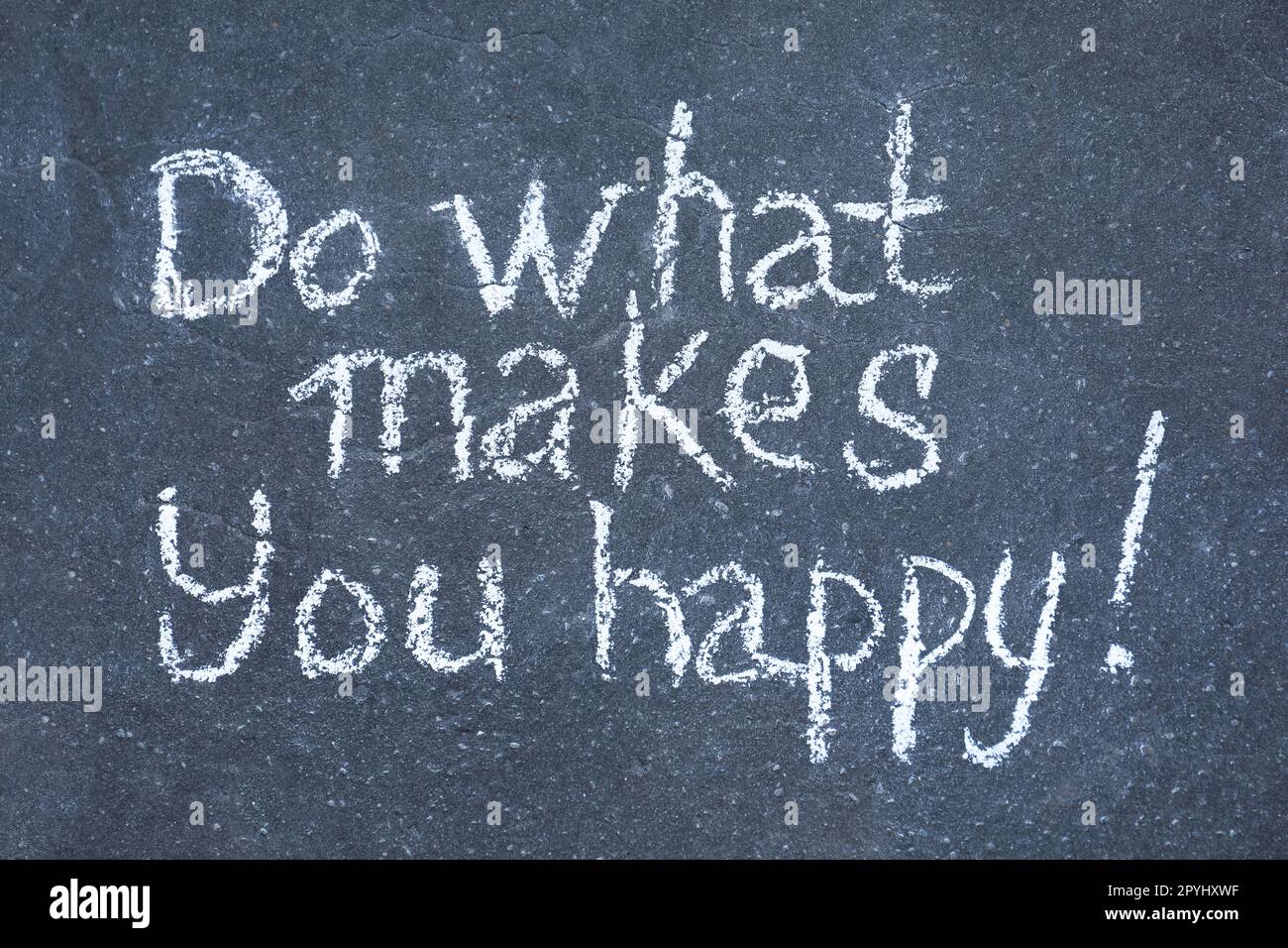 Phrase Do What Makes You Happy with exclamation mark written on asphalt, top view Stock Photo