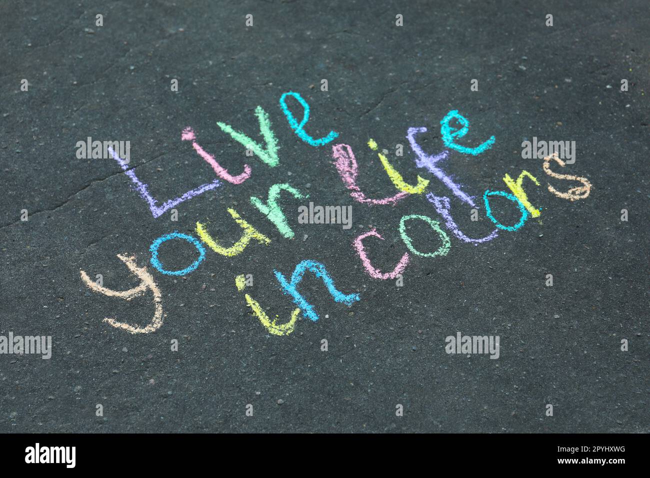 Phrase Live Your Life In Colors written on asphalt Stock Photo