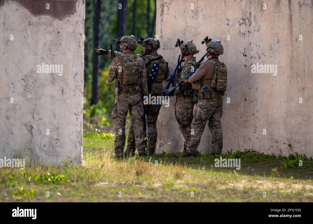 U.S. Air Force Special Operations Surgical Team Members, assigned to the 24th Special Operations Wing, clear a village during Emerald Warrior 23 at Eglin Range, Florida, April 24, 2023. Air Force Special Operations Command professionals are trained to the highest standards, prepared for any environment, and can quickly integrate as enablers in conventional missions. (U.S. Air Force photo by Senior Airman Stephen Pulter) Stock Photo