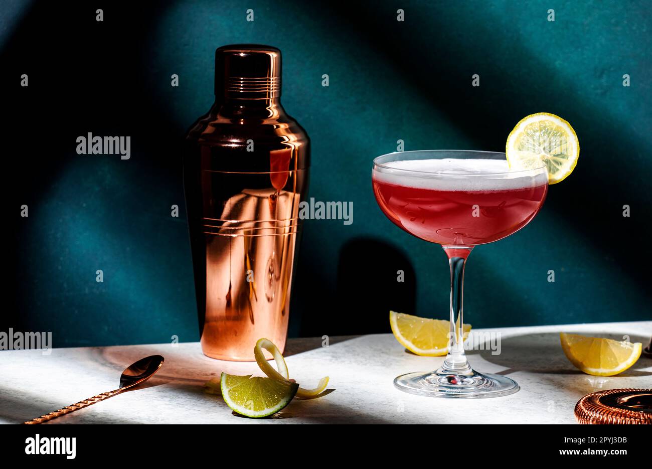 Pink lady classic cocktail drink with dry gin, grenadine syrup, lemon