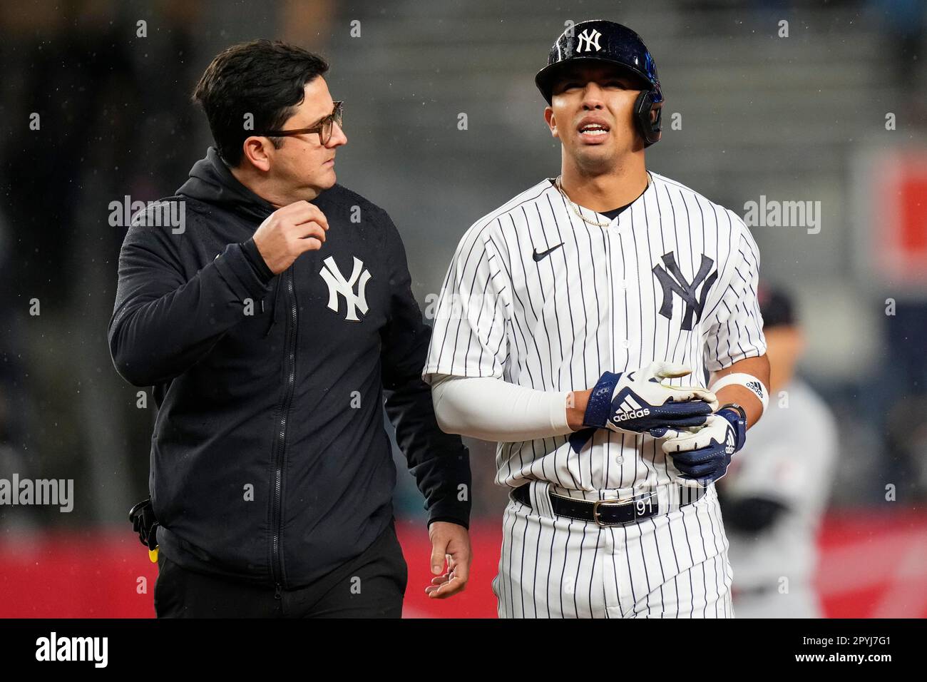 A trainer helps New York Yankees' Oswald Peraza off the field after he was  hurt during the ninth inning of a baseball game against the Cleveland  Guardians, Wednesday, May 3, 2023, in