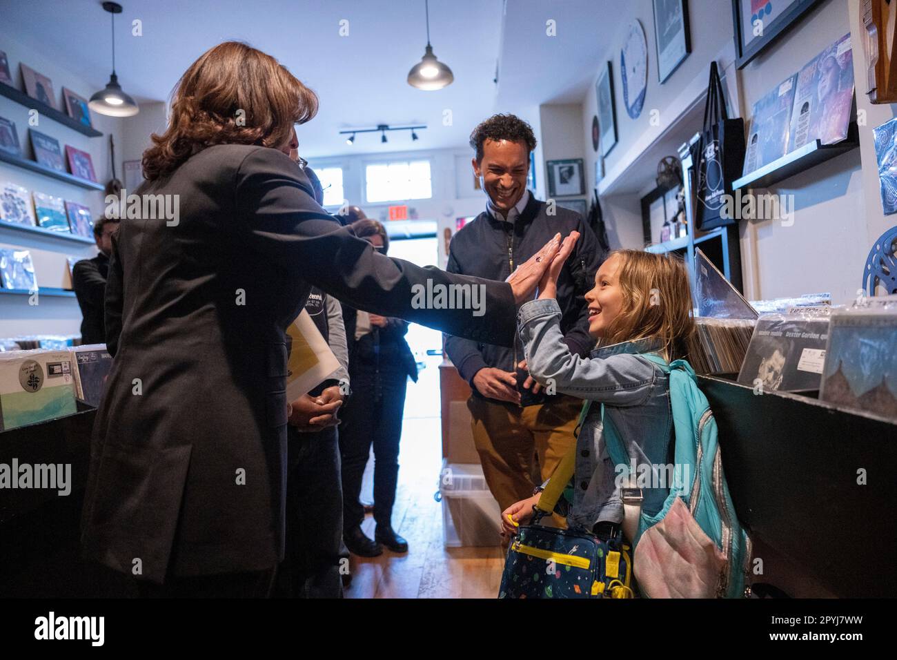 Washington, Vereinigte Staaten. 03rd May, 2023. United States Vice President Kamala Harris high-fives with Esmé Pleasant as her father Zach looks on at Home Rule Record store in Washington, DC on Wednesday, May 3, 2023. Credit: Ken Cedeno/Pool via CNP/dpa/Alamy Live News Stock Photo
