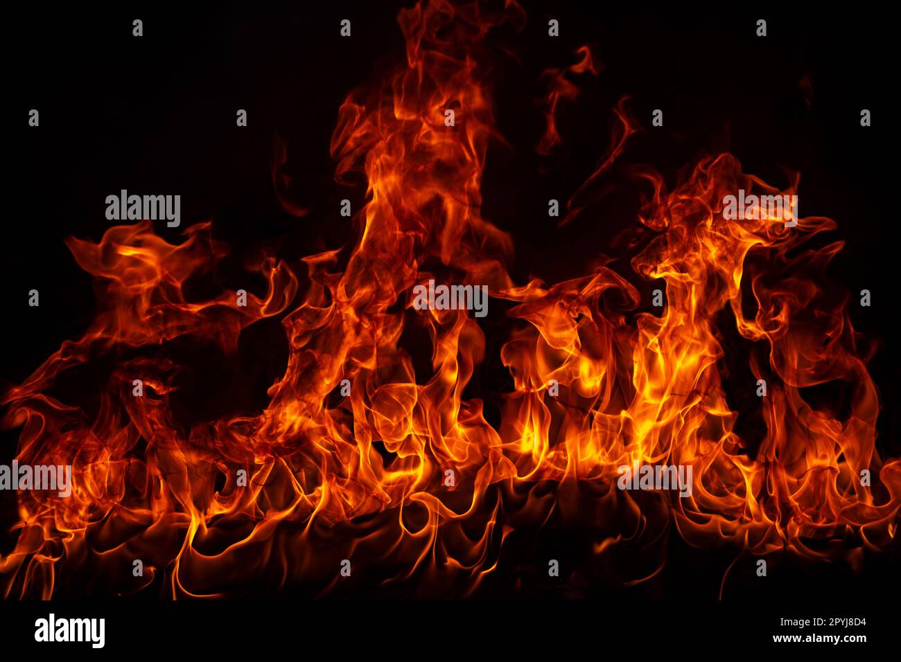 Fire blaze flames on black background. Fire burn flame isolated, abstract texture. Flaming explosion effect with burning fire. Stock Photo