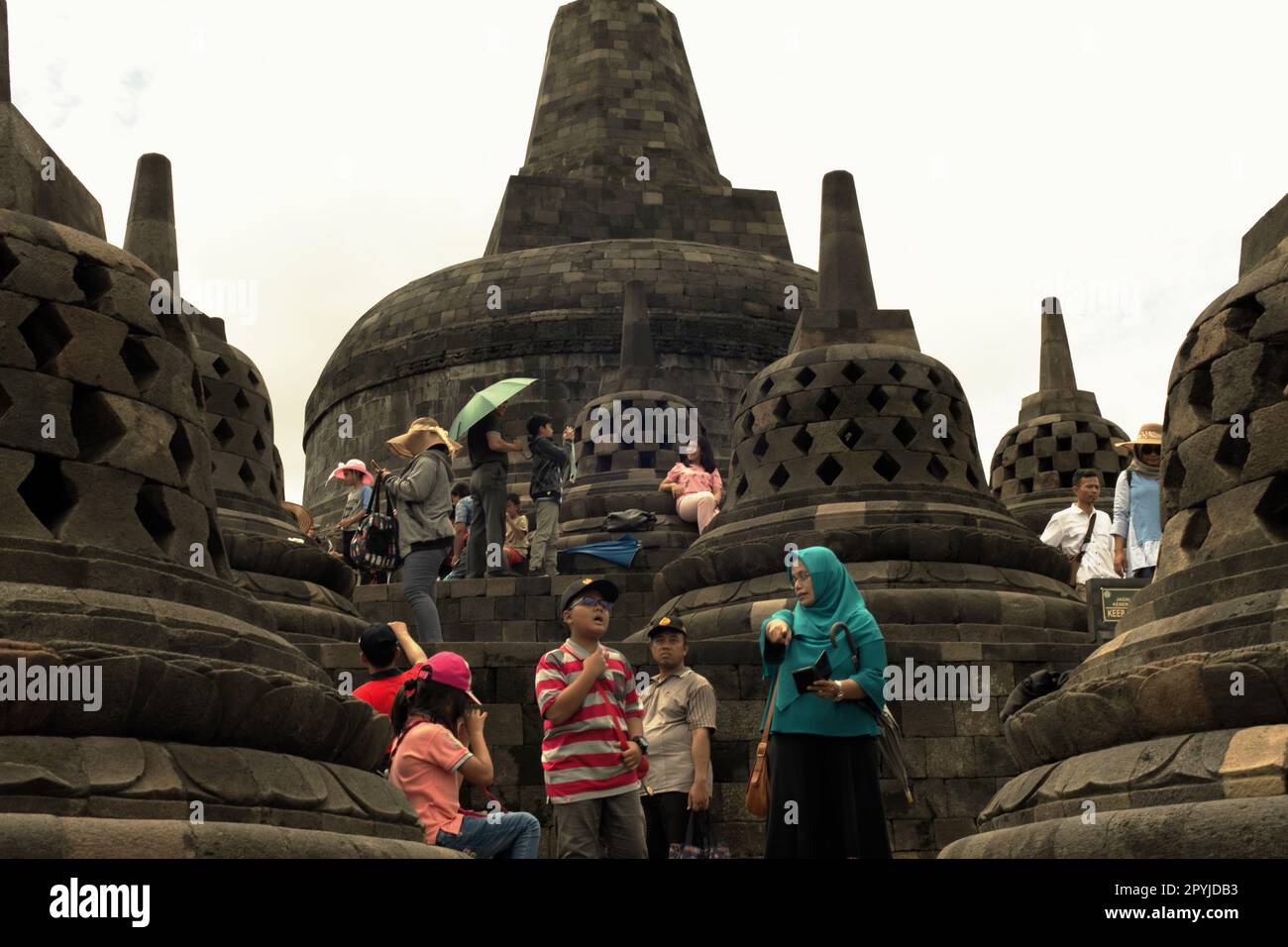 Visitors having recreational time at Borobudur temple in Magelang, Central Java, Indonesia. Borobudur was constructed by Sailendra Dynasty, the same dynasty who ruled Srivijaya kingdom since at least 8th century. Stock Photo