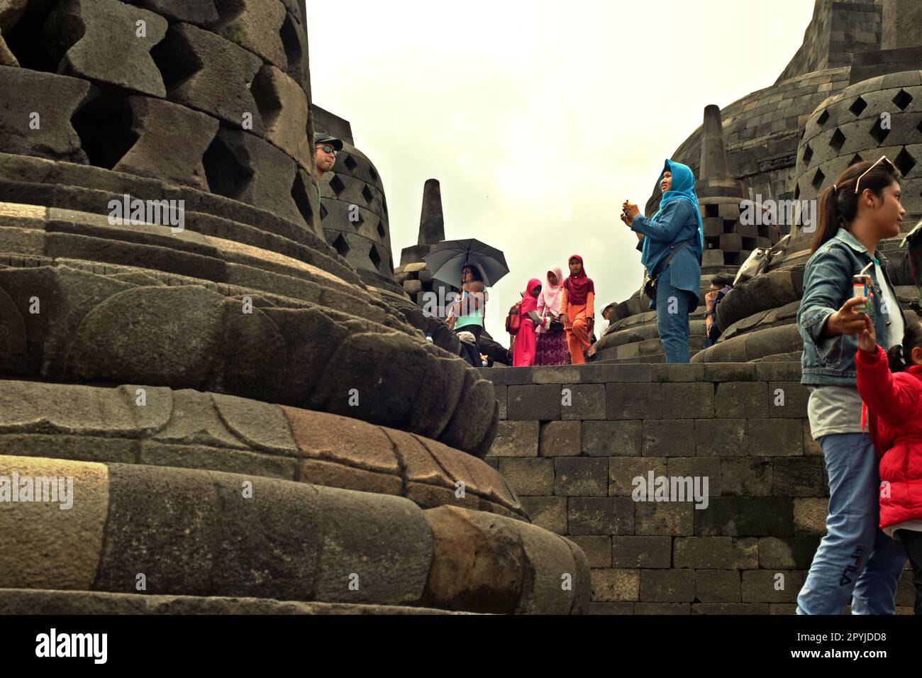 Visitors having recreational time at Borobudur temple in Magelang, Central Java, Indonesia. Borobudur was constructed by Sailendra Dynasty, the same dynasty who ruled Srivijaya kingdom since at least 8th century. Stock Photo