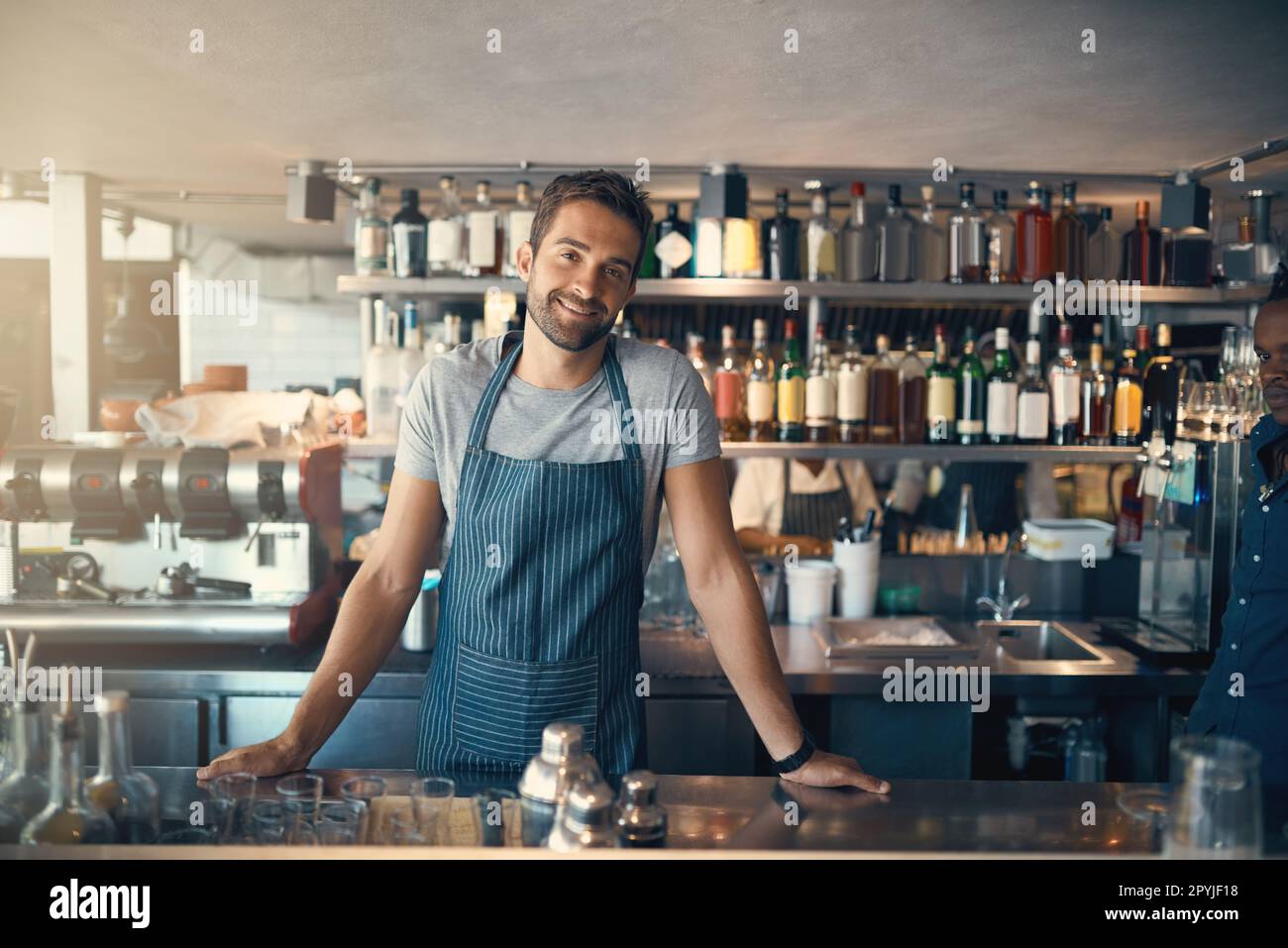 What can I make for you today. Portrait of a young man working behind a