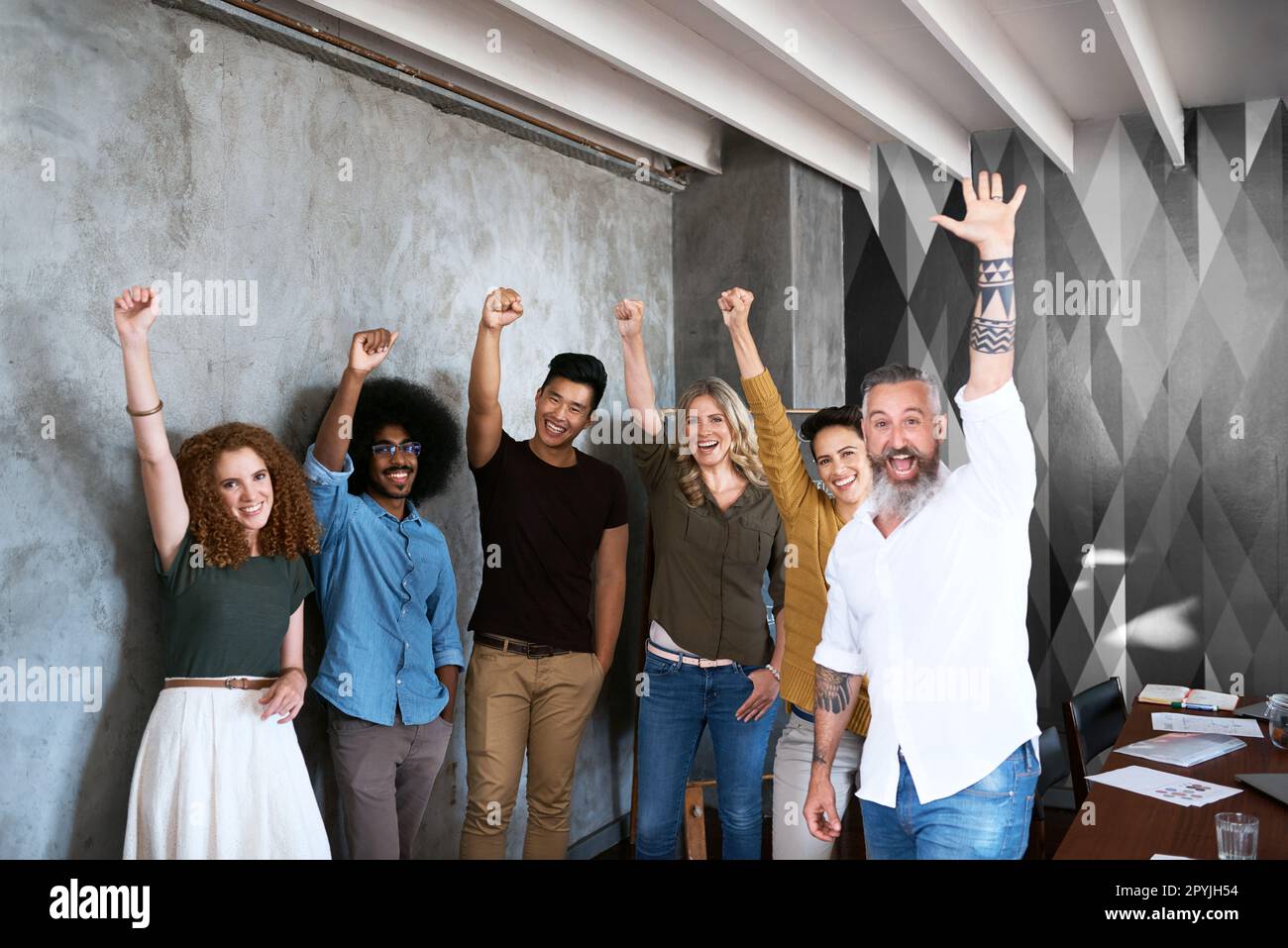 Born to be great. Cropped portrait of a group of designers raising ...