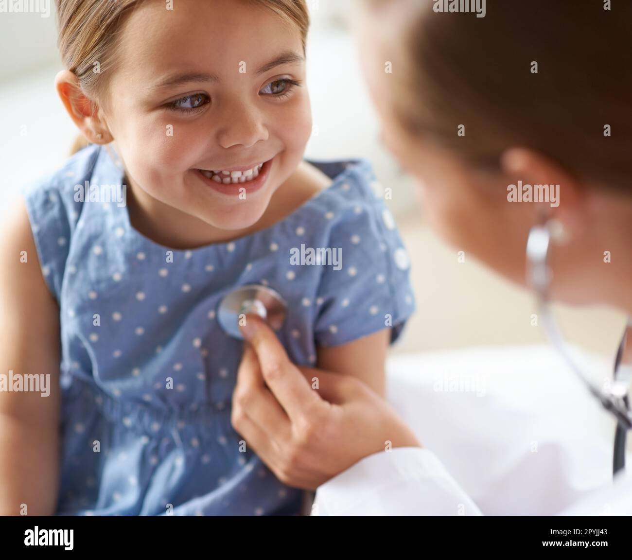 Happy, child and stethoscope of pediatrician for healthcare consulting