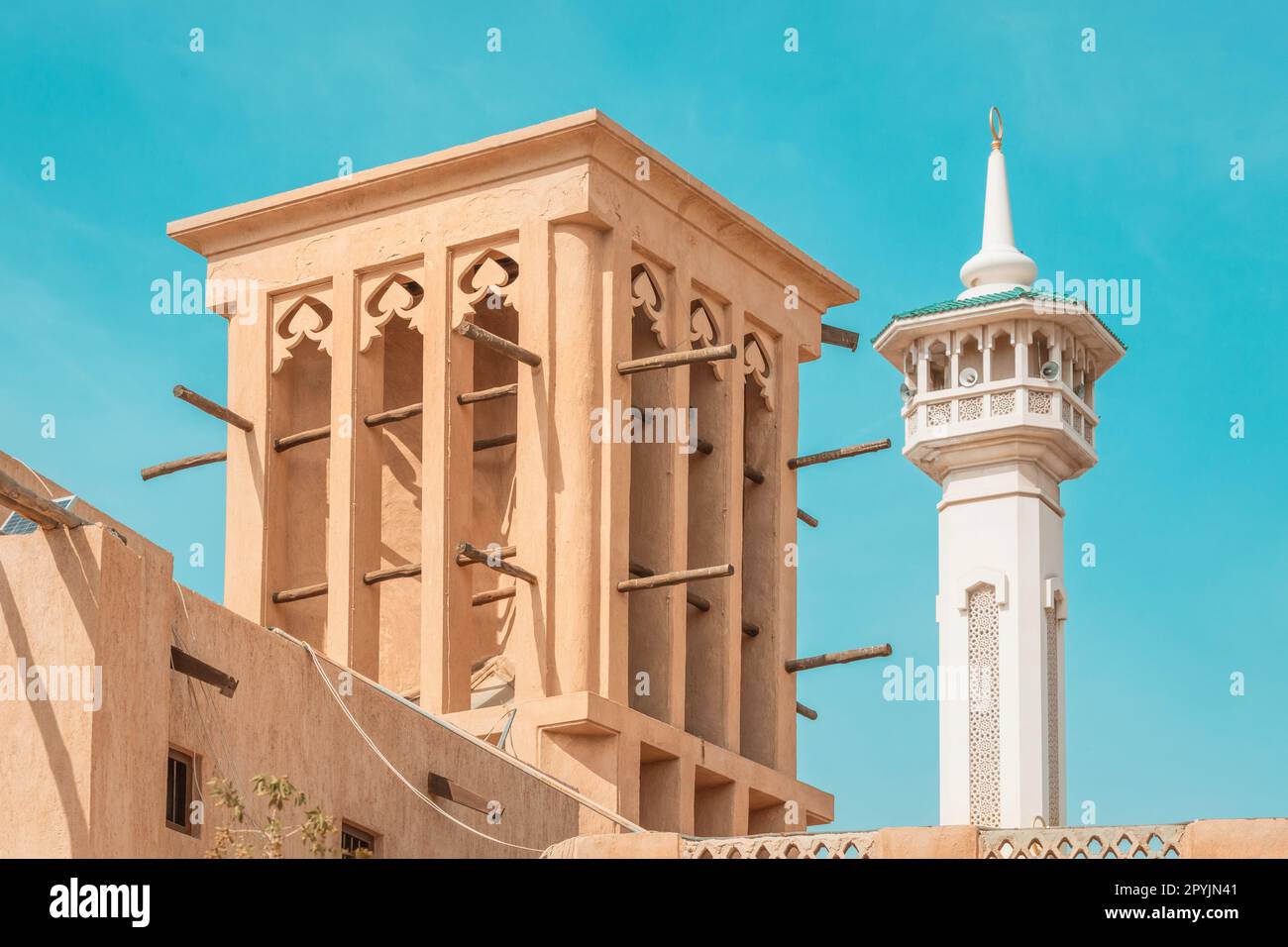 Al Fahidi mosque minaret and traditional arab windtower used for ventilation  and air conditioning at historical district and neighbourhood in Bur Duba  Stock Photo - Alamy