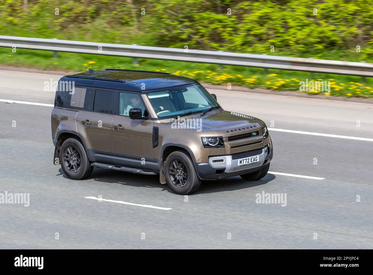2022 Land Rover Defender Se D Mhev Auto D250 AWD MHEV 48V Auto Start/Stop Brown LCV Hardtop Van Diesel 2997 cc;  travelling on the M61 motorway UK Stock Photo