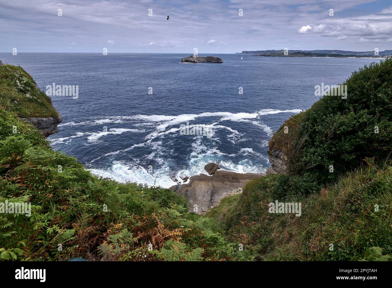 A lighthouse on the Cantabrian Sea coast, and coast line Stock Photo