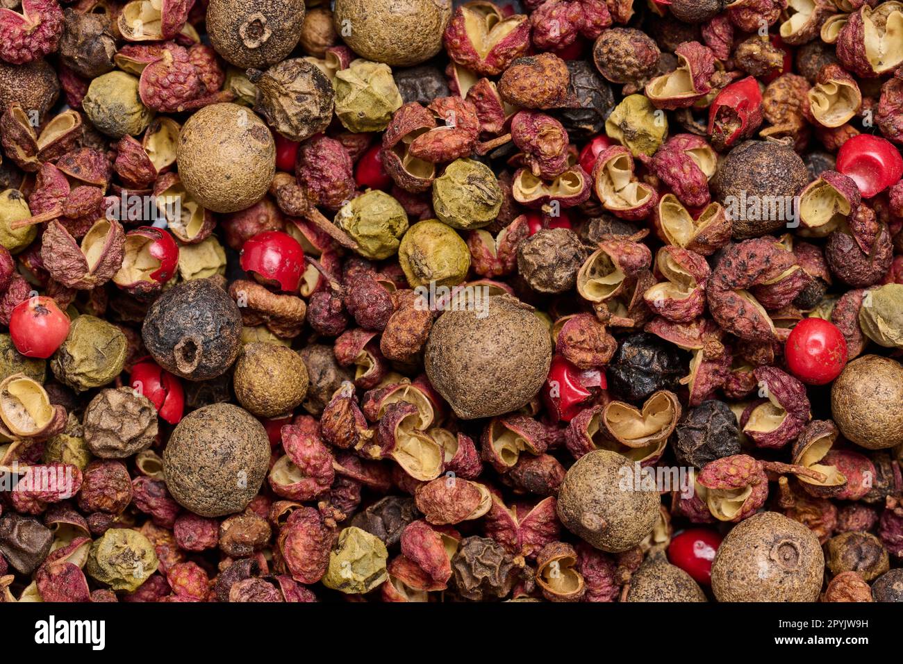 Various mixture of peppers, red, black and allspice. Seasoning for cooking Stock Photo