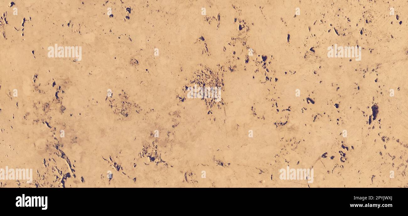 Sandstone or beige marble. Smooth surface with small dark brown blotches and indentations. Evening sunny side lighting. Fragment of a historic stone building on Kalemegdan, Belgrade, Serbia. Stock Photo