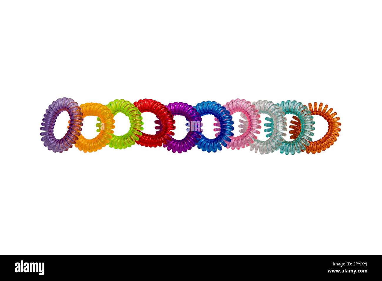 Hair care tools isolated. Close-up of multicolored elastic spiral scrunchies or hair bands for women hairstyling. Clipping path. Tools from hairdresser and beauty salon. Stock Photo