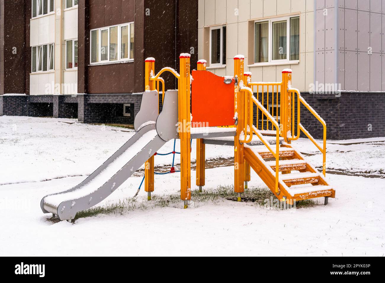 Play complex playground with slides and stairs in the winter city Stock Photo