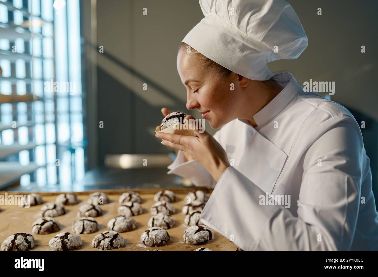 Smelling Delicious Female chef smelling tray cookies hi-res stock photography and images ...