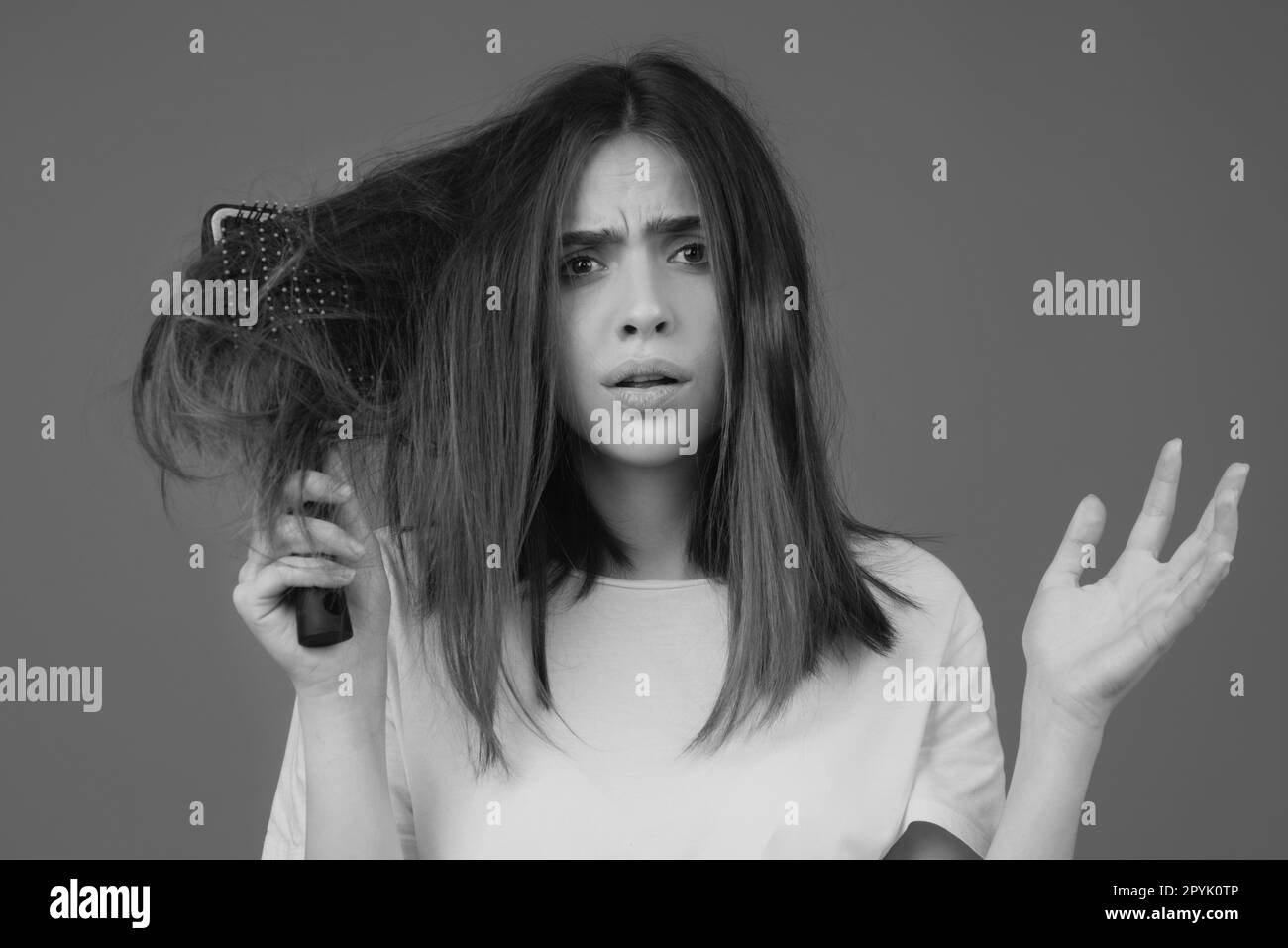 Hair loss woman with a comb and problem hair. Hairloss stressed woman