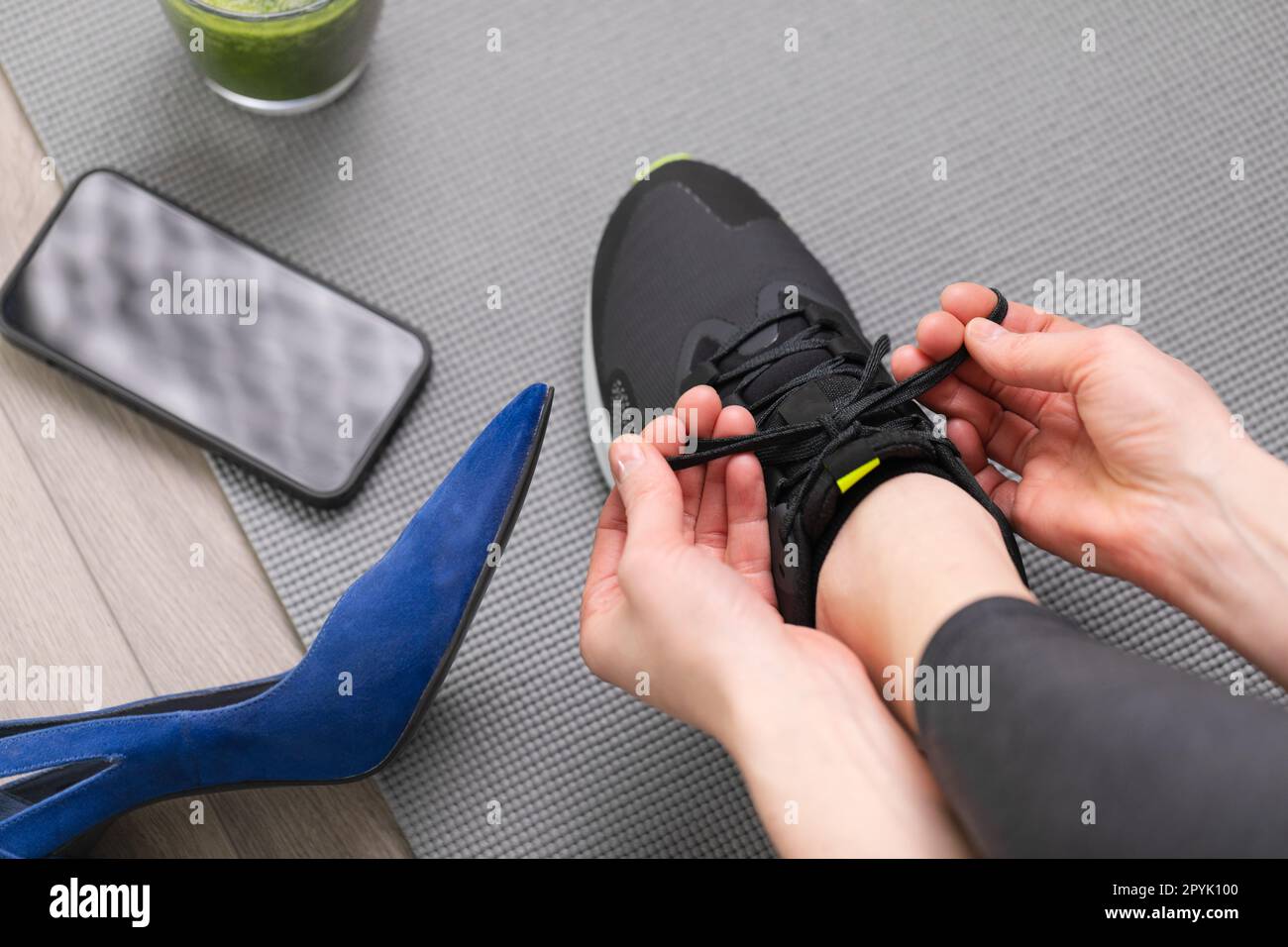 Woman changing high heels to sport running shoes. Exercise after office