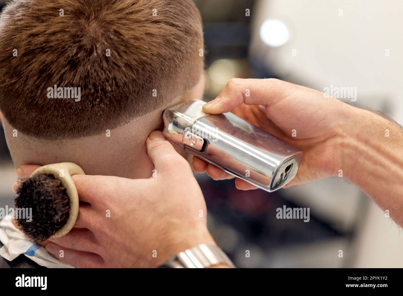 Barber trim hair with clipper on handsome bearded man Stock Photo