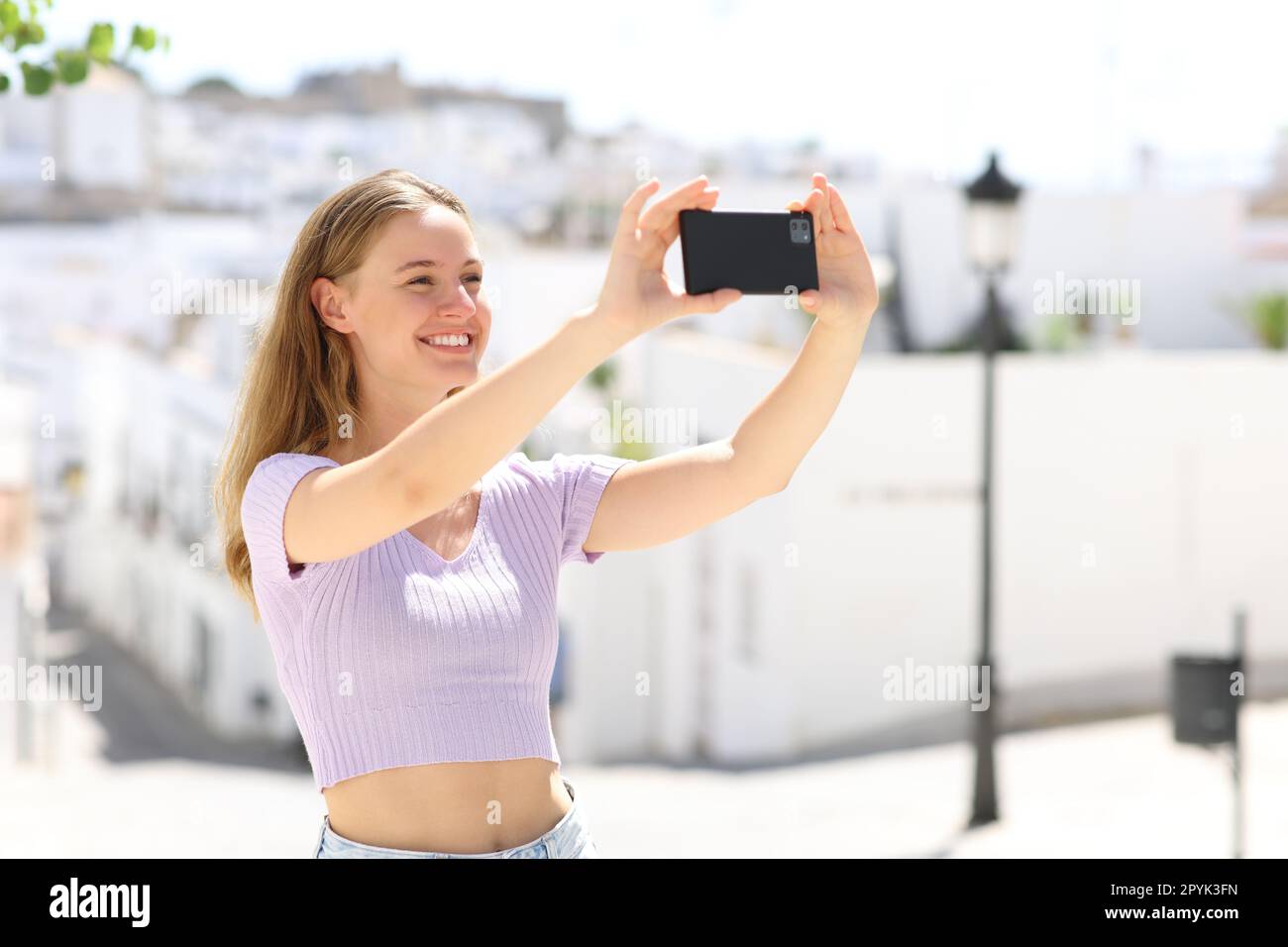 Teen taking slefie or photo in a town Stock Photo