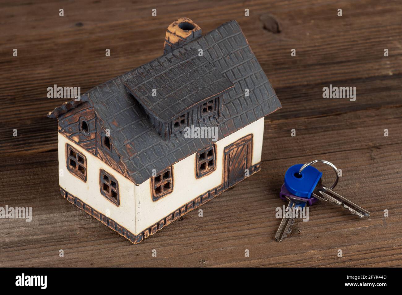 Model house and keys on table. Stock Photo