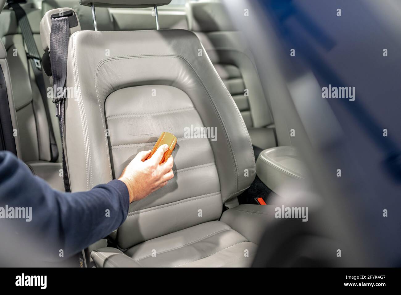 cleaning leather seats of luxury cars with the help of detergents and