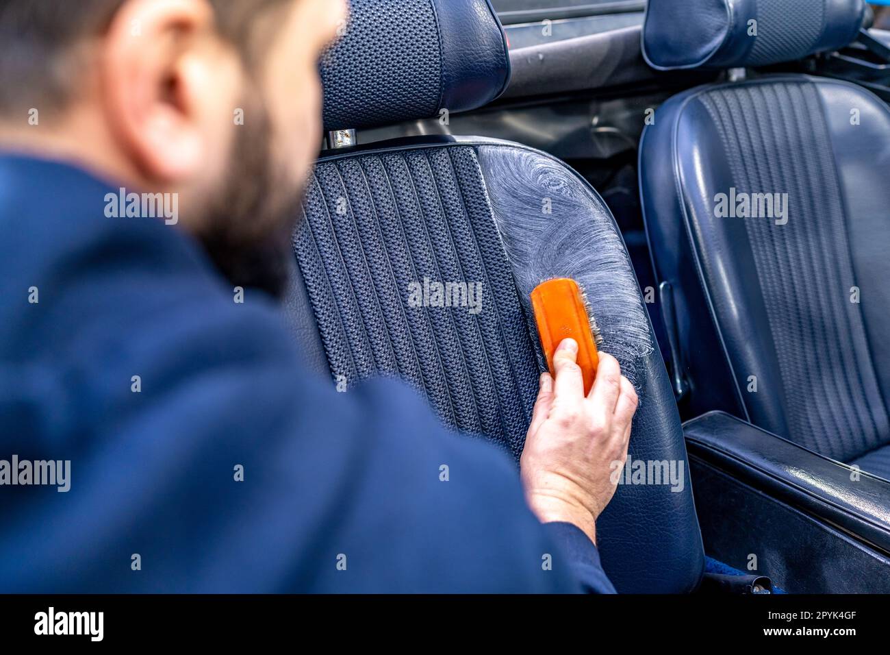 cleaning leather seats of luxury cars with the help of detergents and