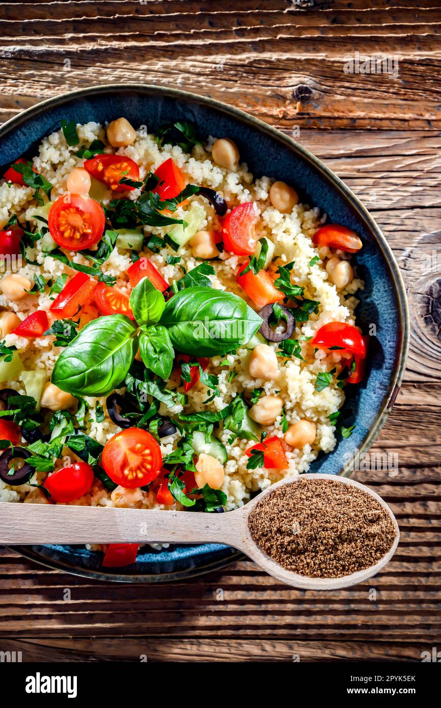 A plate of couscous served with vegetables and chickpeas Stock Photo