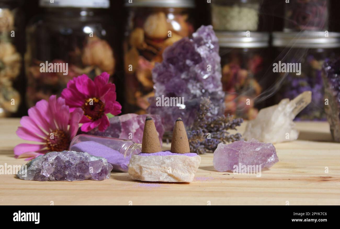 Amethyst Crystals With Flowers and Incense Cones on Meditation Table Stock Photo