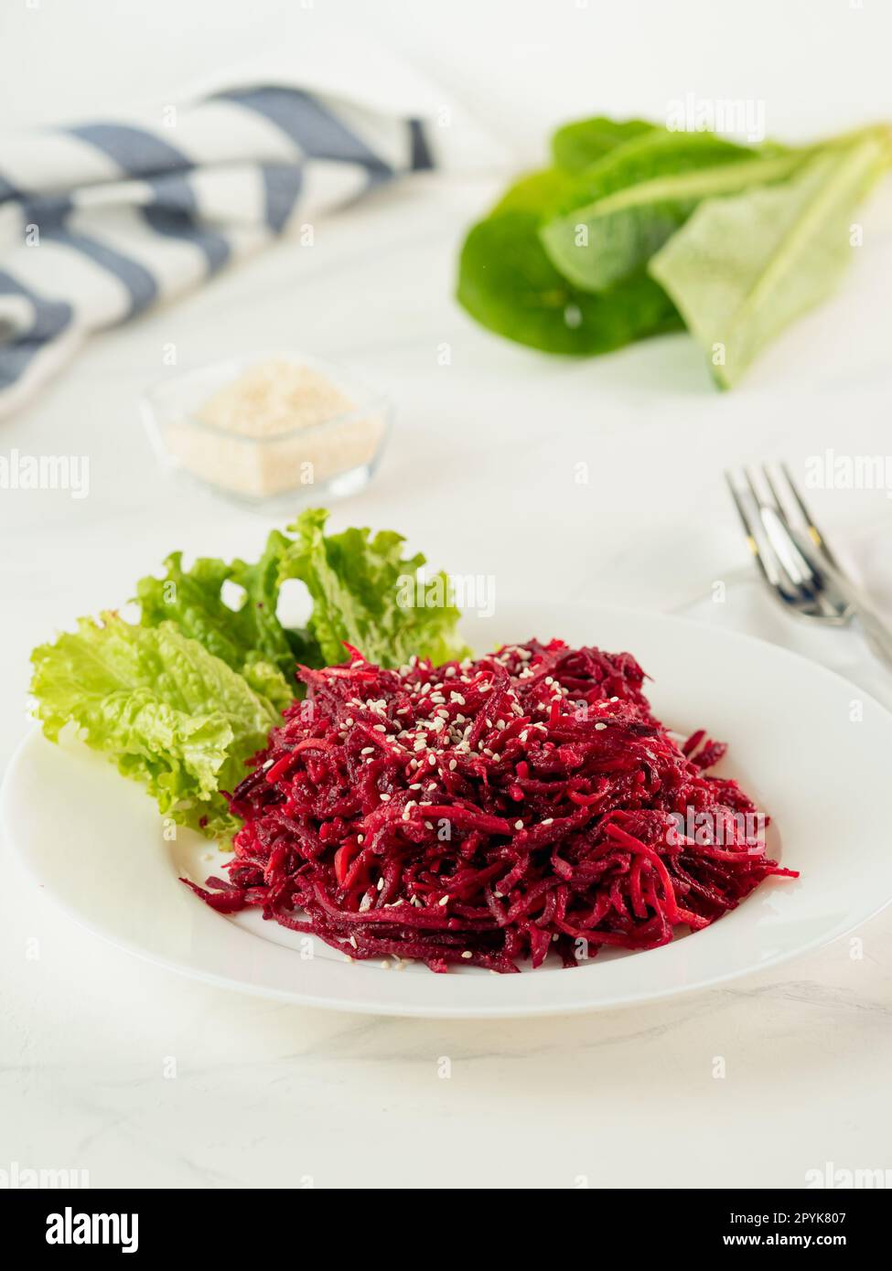 Beetroot salad on white table, vertical Stock Photo - Alamy