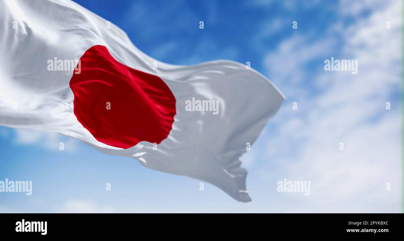 Japan national flag waving in the wind on a clear day. Red disc on a white field. Japan is an