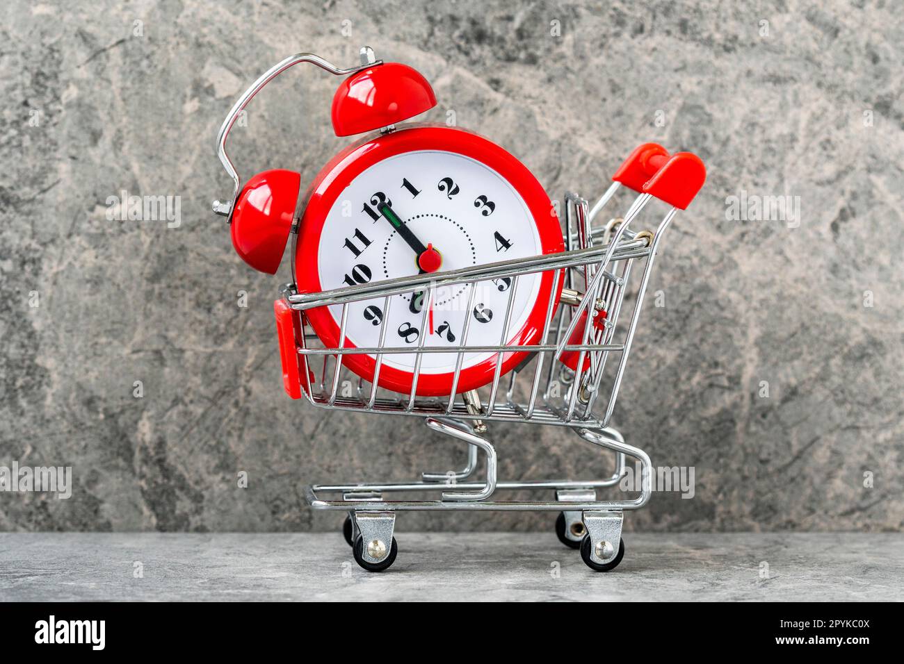 Buying time concept with clock and shopping cart Stock Photo