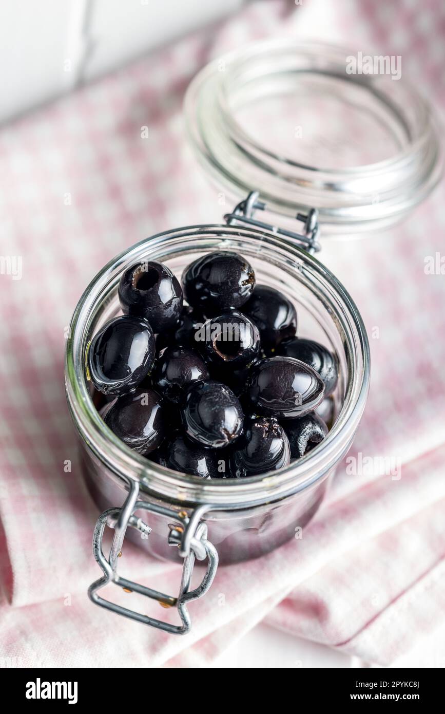Pitted black olives in jar Stock Photo Alamy