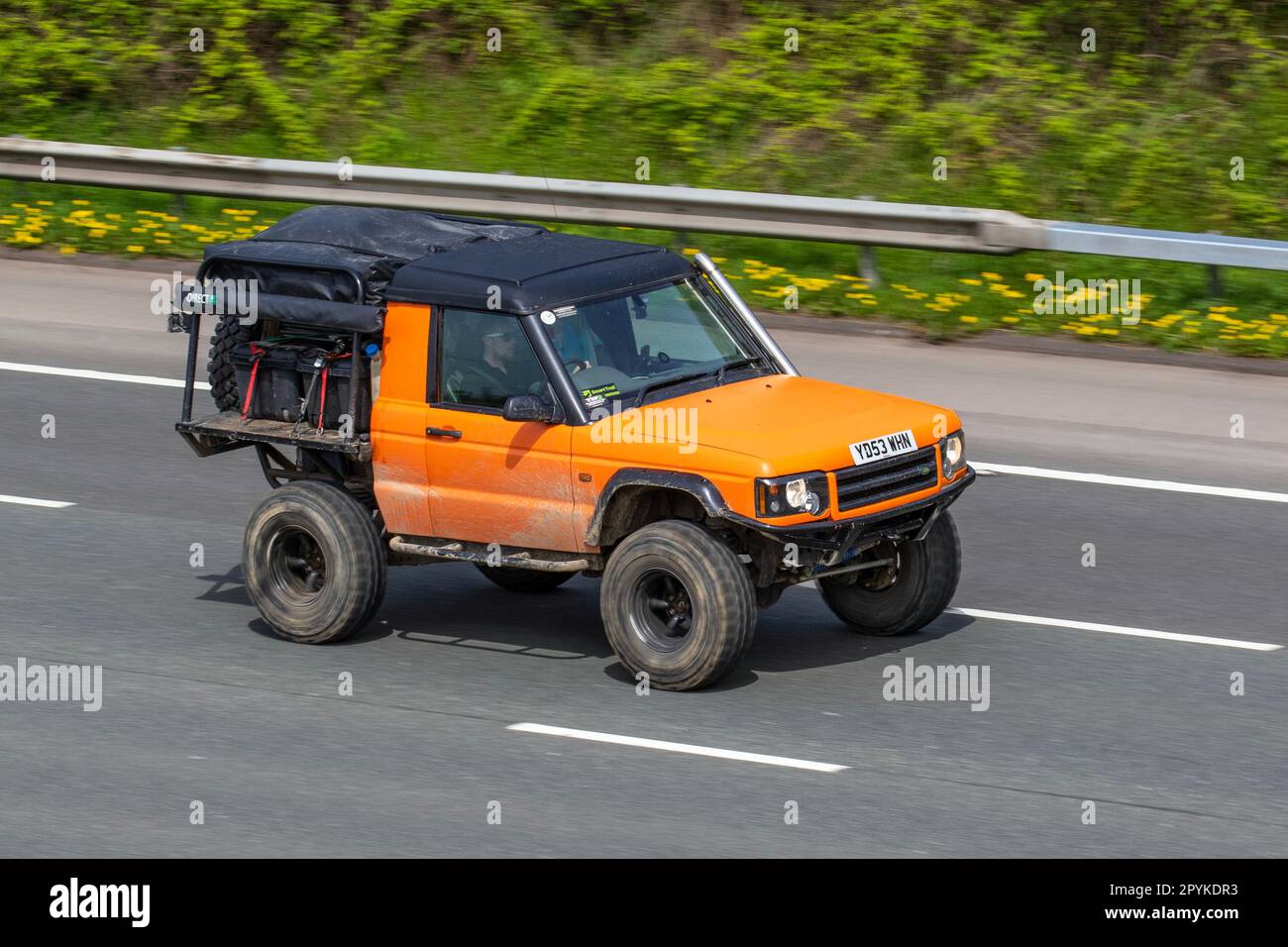 Land Rover Discovery Td5 Gs Td5 138 Gold Car Hardtop Diesel 2495 cc;  Peculiar Unusual Modified radically altered, 2dr, two door, 2 door,   travelling on the M61 motorway UK Stock Photo