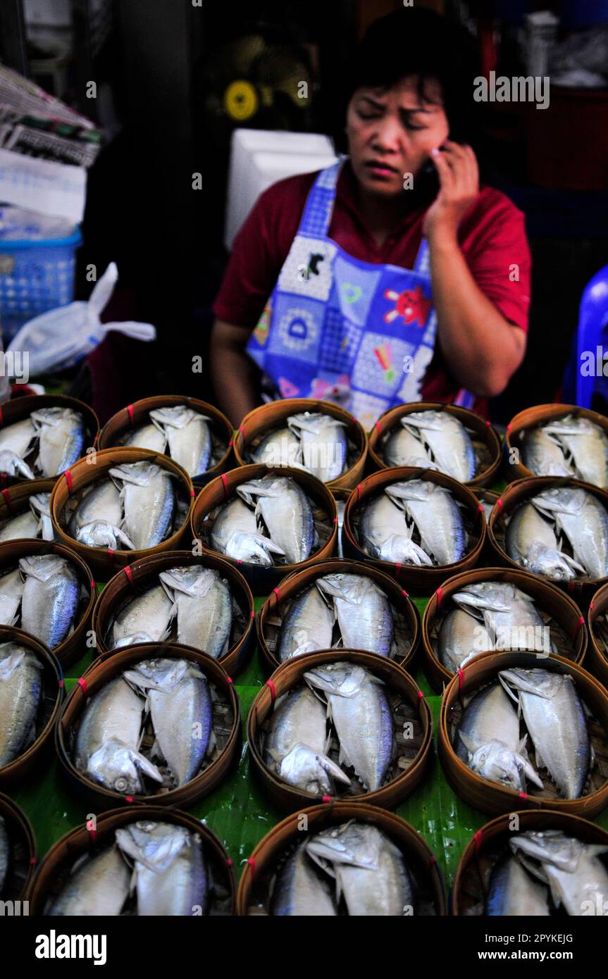 Steamed Thai Mackerel fish from Gulf of Thailand in bamboo basket for sale at the Mae Klong Railway Market Southwest  of Bangkok, Thailand. Stock Photo