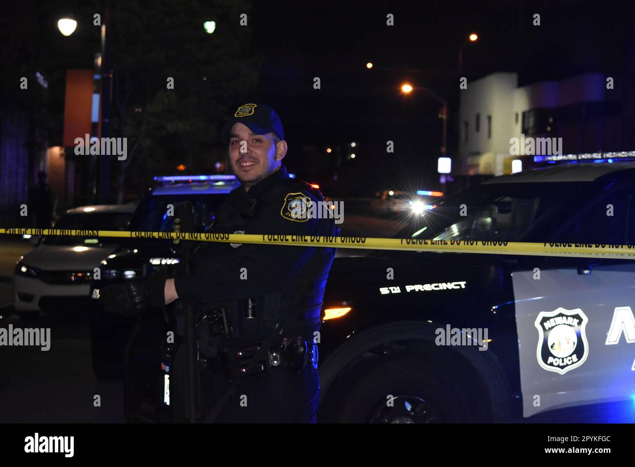 Police officer from Newark police secures the crime scene with a long ...