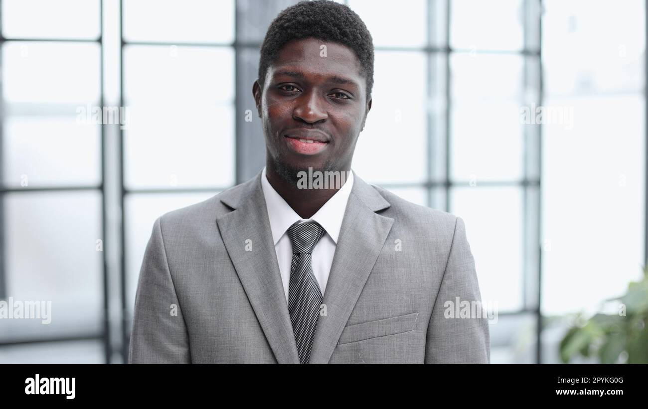 Smiling millennial confident black guy posing for photo, looking at camera Stock Photo