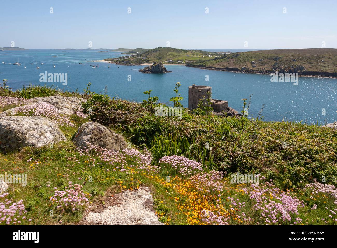 View over New Grimsby Sound from Castle Down, with Cromwell's Castle below, Bryher on the right and the Garrison on St. Mary's in the far distance: Tr Stock Photo
