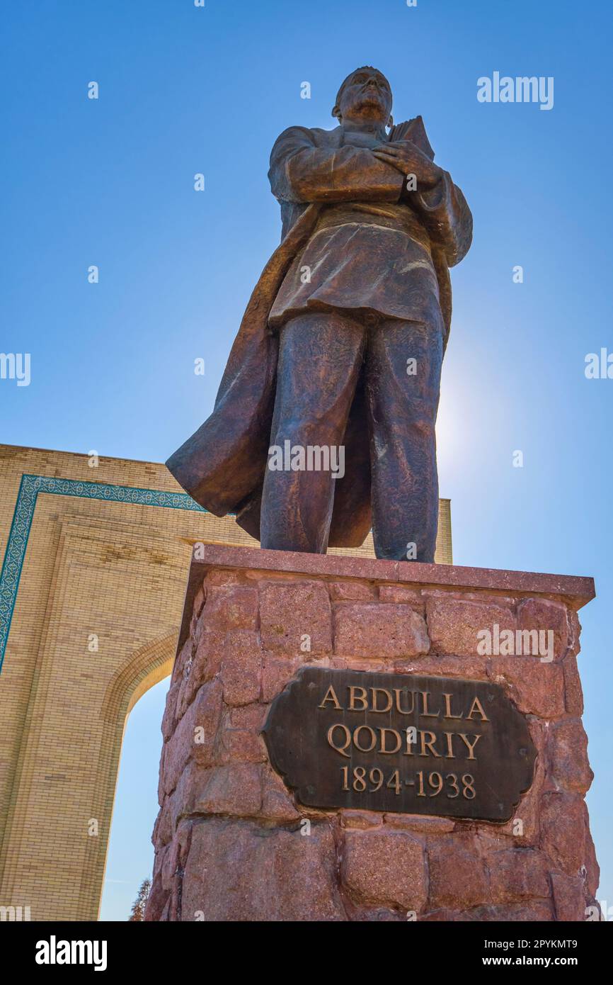 A large bronze sculpture of a standing Abdulla Qodiriy, famous writer ...