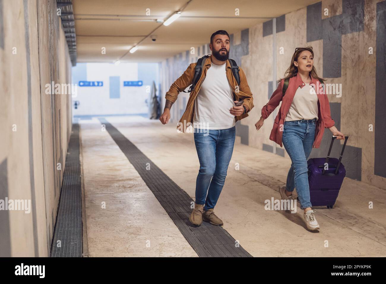 Adult couple is in a hurry to catch the train on time. Stock Photo