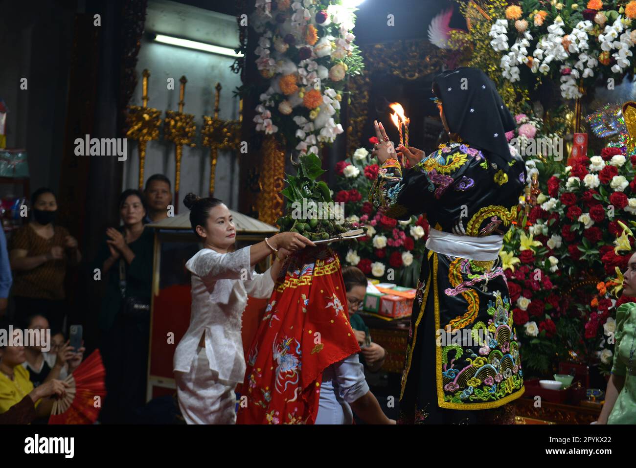 Shaman plays the role of a god performing rituals to transmit messages in Mother Goddess Worship event. Vietnam. Asia Stock Photo
