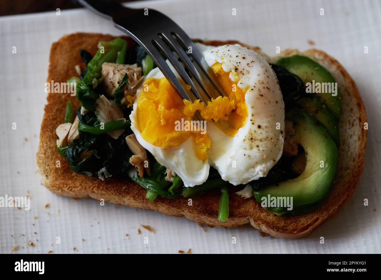 Open faced sandwich, topped with poached egg, tuna and avocado Stock ...