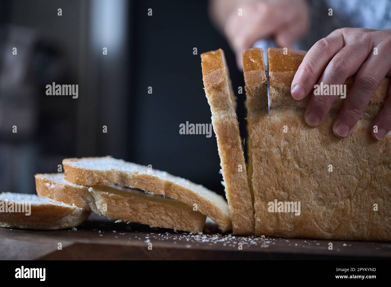 https://c8.alamy.com/comp/2PYKYND/cutting-whole-grain-loaf-with-bread-slicer-2PYKYND.jpg