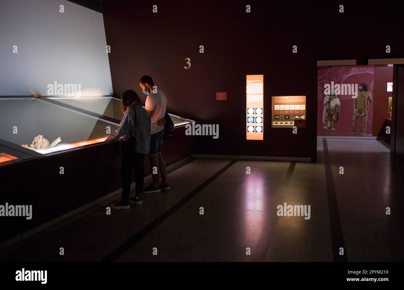 Alcala de Henares, Spain - Oct 10th, 2020: Visitors observing the exhibition at National Archeological  Museum of Madrid. Regional Archaeological Muse Stock Photo