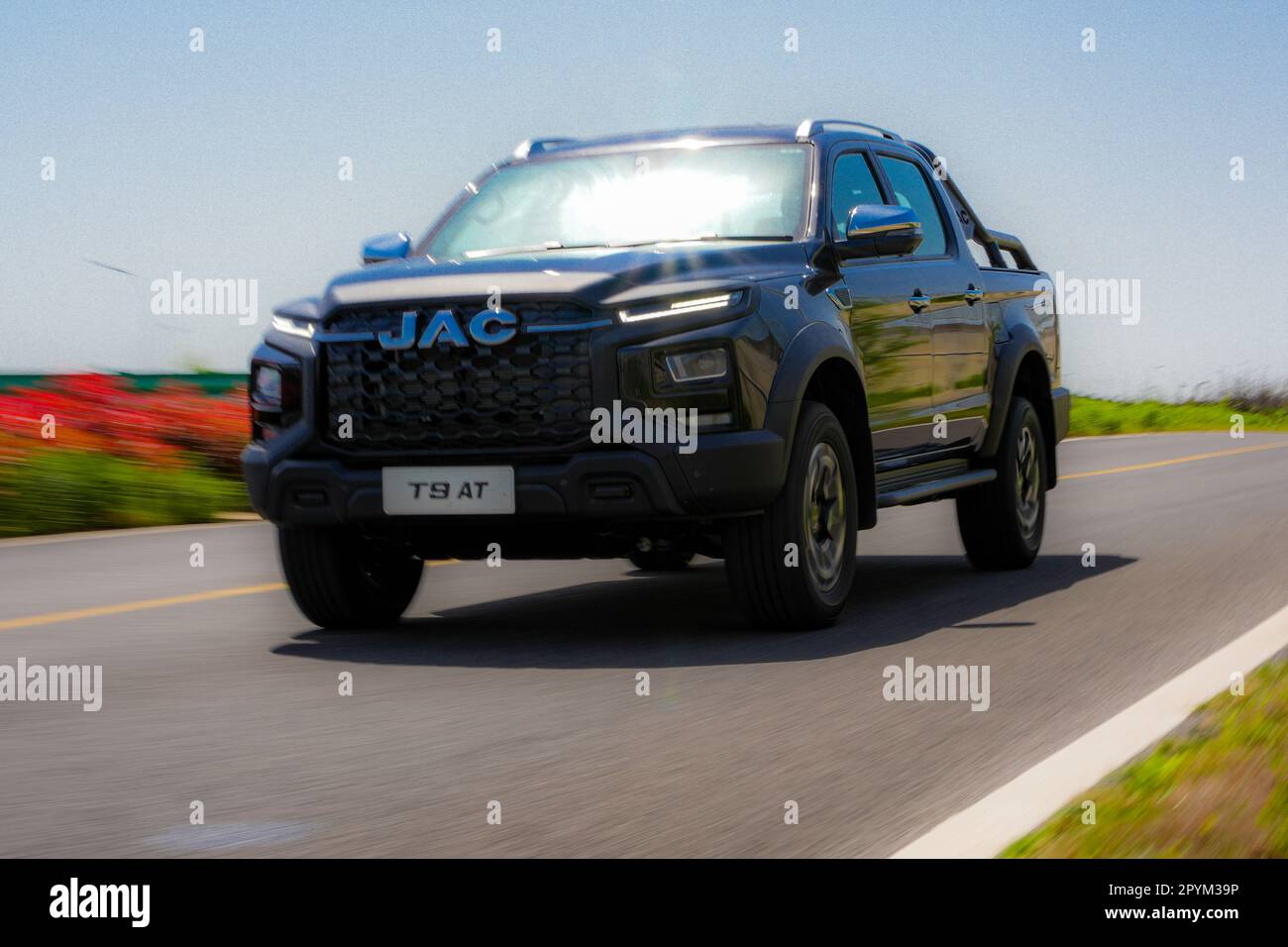Anhui Province, China – 17042023: South African spec right hand drive JAC T9 pickup truck being driven on a track during a test drive. Stock Photo